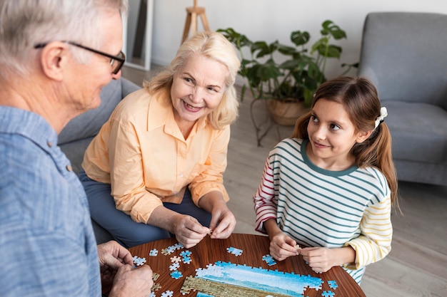 Close up family doing puzzle