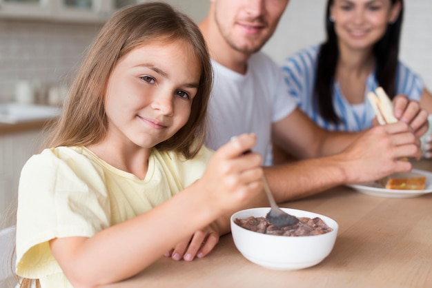 Close-up family eating in kitchen