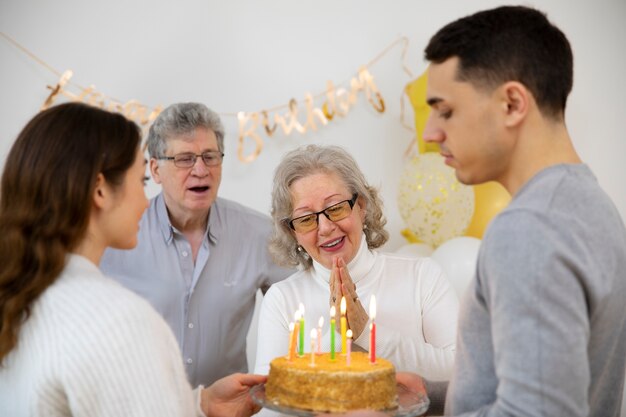 Close up family holding birthday cake