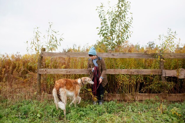 Close up on farmer spending time with dog