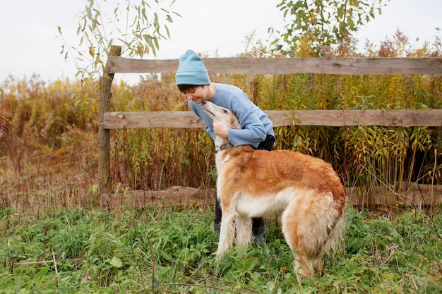 Free photo close up on farmer spending time with dog