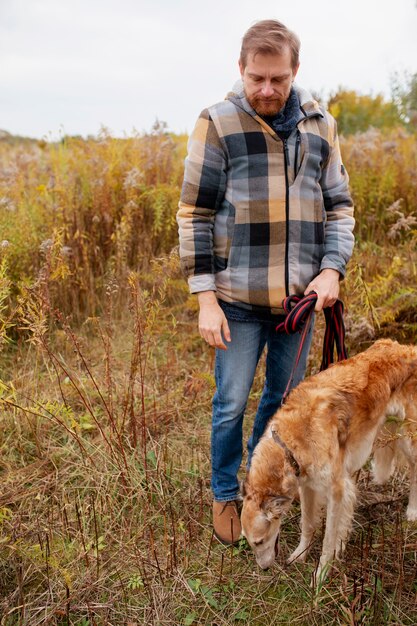 Close up on farmer spending time with dog