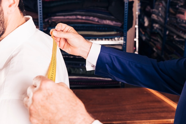 Close-up of fashion designer's hand taking measurement