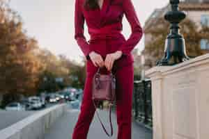 Free photo close up fashion details of stylish woman in purple suit walking in city street, spring summer autumn season fashion trend holding purse