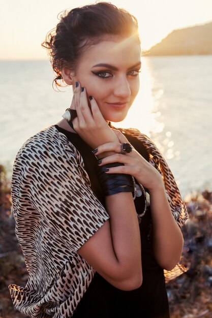 Close Up fashion portrait of beautiful smiling woman at sunshine. Smokey eyes look.