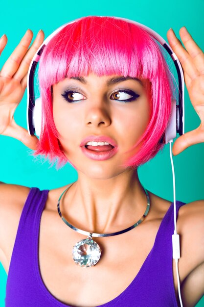 Close up fashion studio portrait of beautiful young woman wearing massive diamond trendy necklace