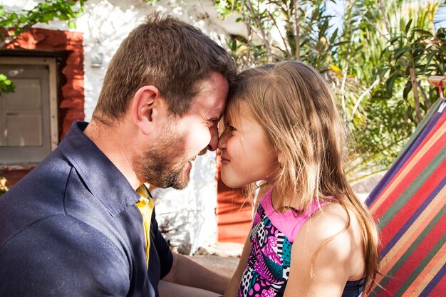 Close-up of father and daughter looking at each other