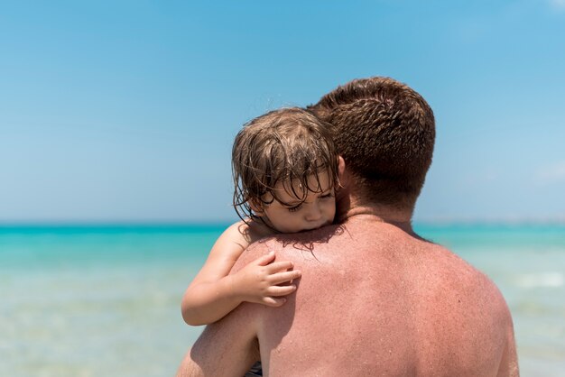 Close up father hugging his son