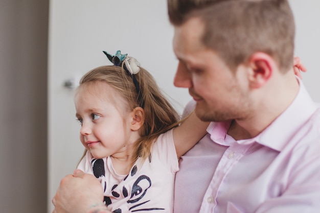 Close-up of father looking at his daughter