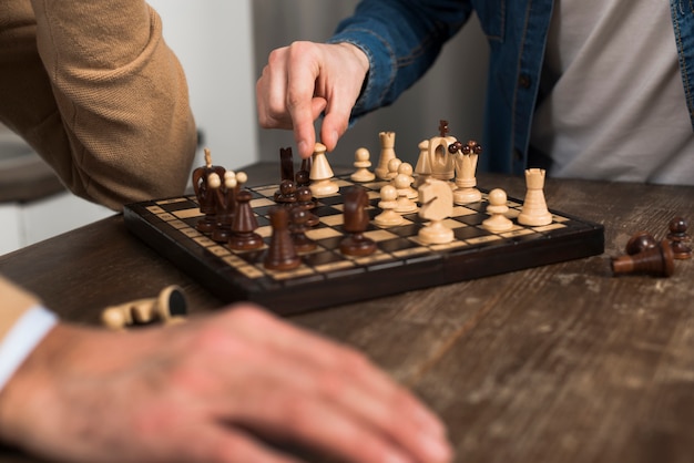 Close-up father and son playing chess