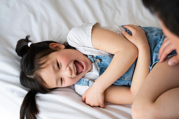 Close up father tickling girl