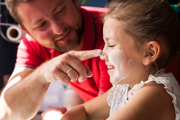 Close-up of father touching his daughter's nose