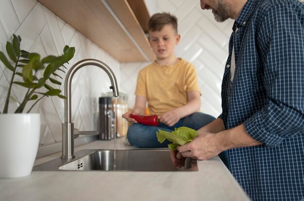 Close up father washing vegetable