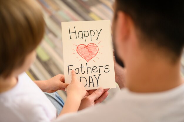 Close-up father with greeting card