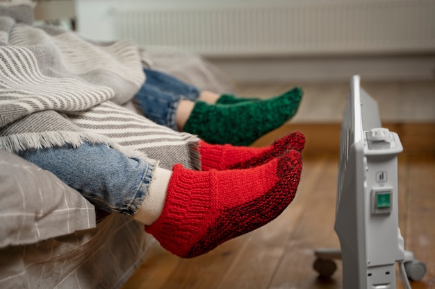 Close up feet getting warm near heater