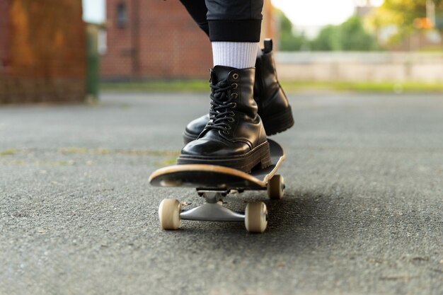 Close up feet on skateboard in suburbs
