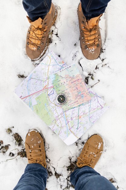 Close up feet with maps and snow