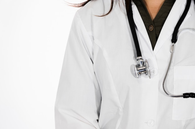 Close-up of female doctor with stethoscope around her neck isolated on white backdrop