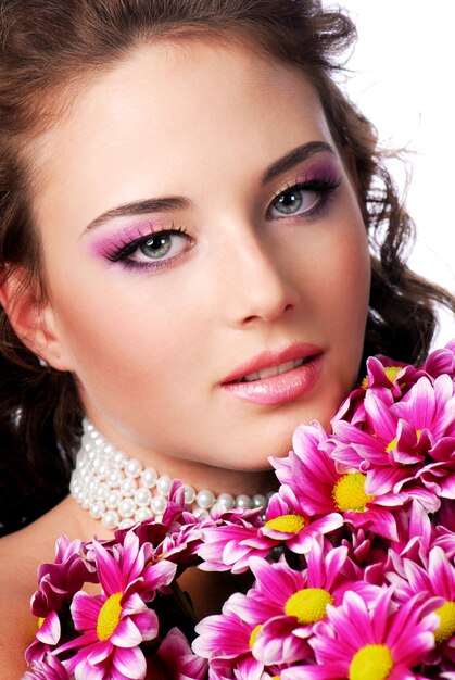 Close-up of female face with pink chrysanthemum. Wedding concept.