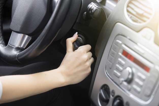 Close-up of female hand adjusting a rear-view mirror