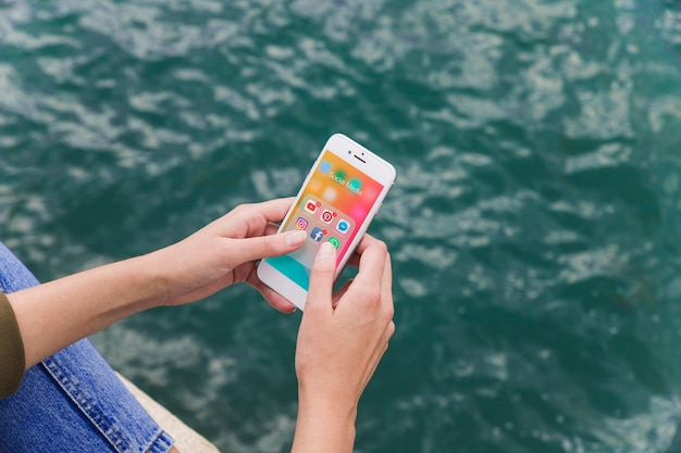 Free photo close-up of a female hand using cellphone with social media notifications on screen