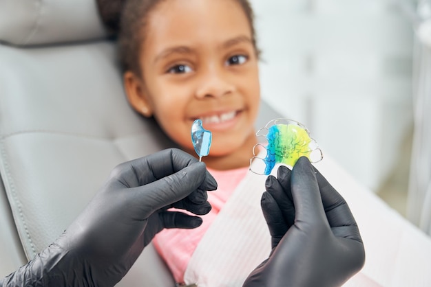 Close up of female hands in gloves holding colorful braces