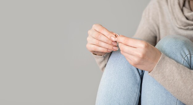 Close-up female holding marrige ring