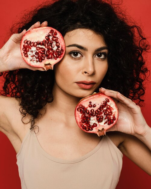 Close-up female holding pomegranate