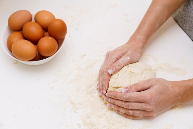 Close-up female making dough