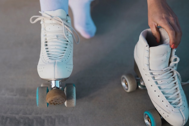 롤러 스케이트를 제거하는 여성 스케이팅의 클로즈업