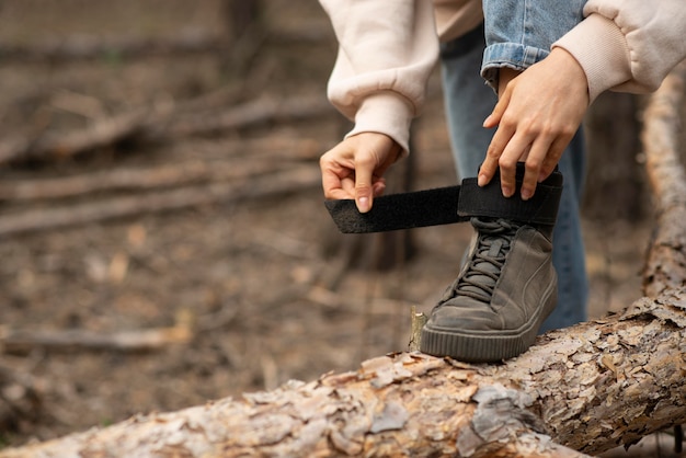 Close-up female tying shoes laces