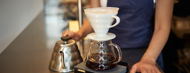 Free photo close up of filter coffee brewing kit and kettle cafe barista preparing filter at the counter