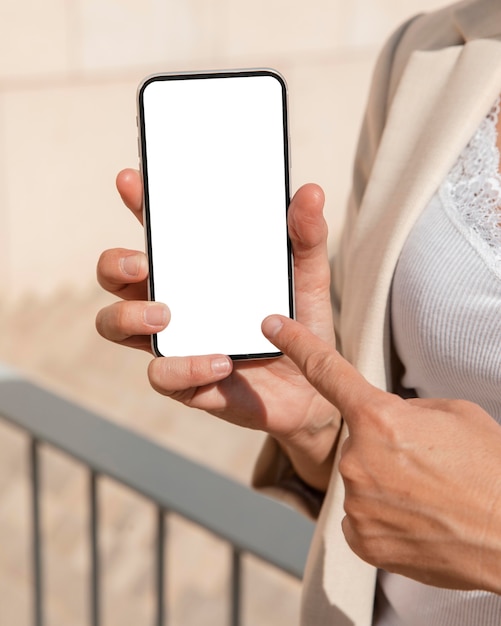 Close-up finger pointing at phone