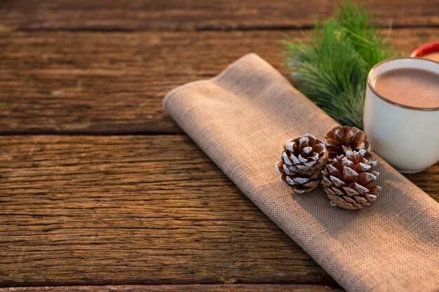 Close-up of fir cones and cup of coffee