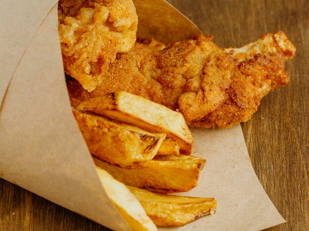 Close-up of fish and chips in paper wrap