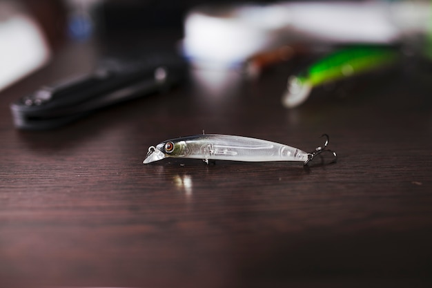 Close-up of fishing lure on wooden desk