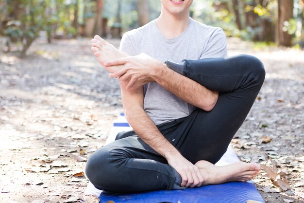 Close-up flexible man stretching his legs