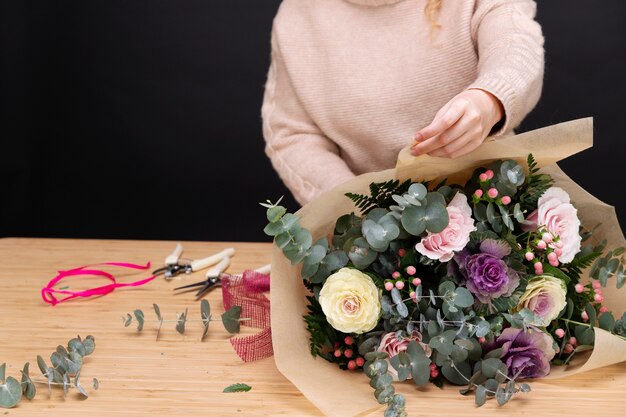 Close up florist making bouquet