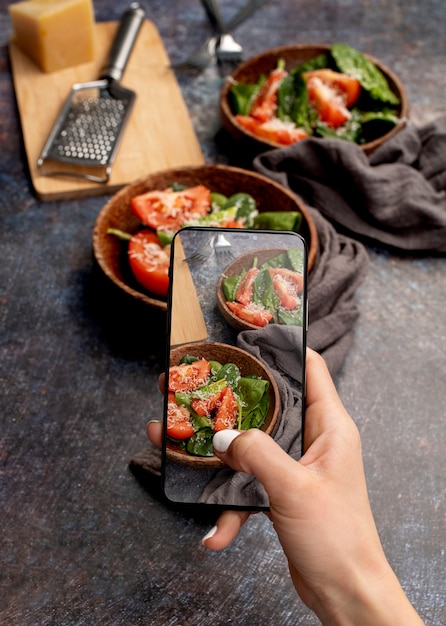 Close up on food lover taking pictures of meal