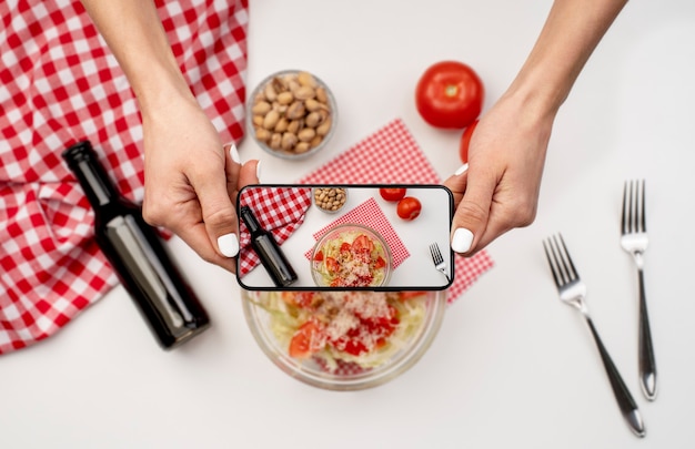 Close up on food lover taking pictures of meal