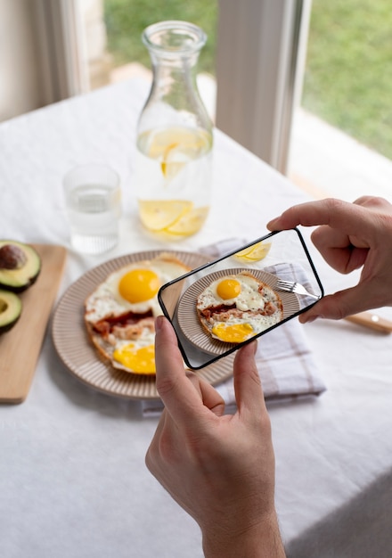 close up on food lover taking pictures of meal