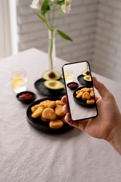 Free photo close up on food lover taking pictures of meal