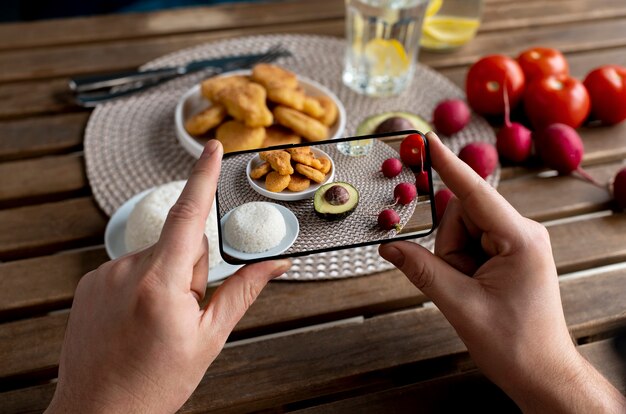 食事の写真を撮る食品愛好家のクローズアップ