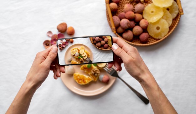 Close up on food lover taking pictures of meal