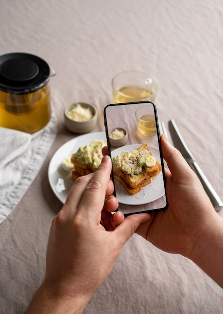close up on food lover taking pictures of meal