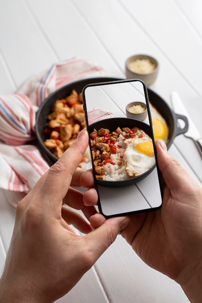 Free photo close up on food lover taking pictures of meal