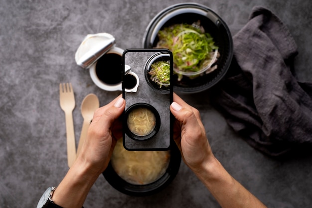 食事の写真を撮る食品愛好家のクローズアップ