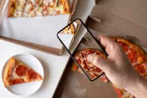 Free photo close up on food lover taking pictures of meal