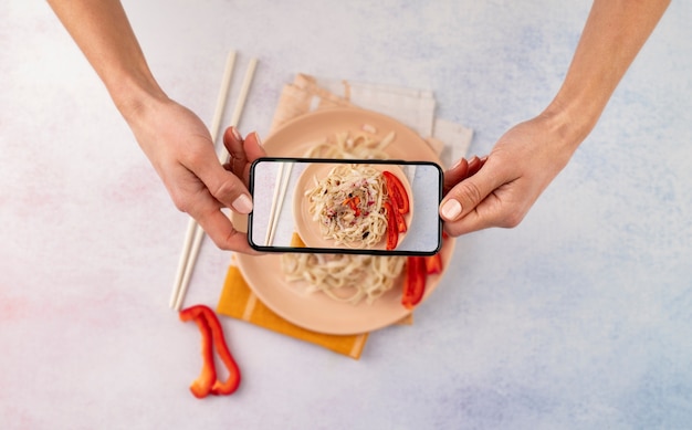 Close up on food lover taking pictures of meal