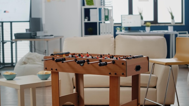 Close up of foosball table to play football game in empty office. Table used for soccer game after work in space to celebrate party with drinks and entertainment. Workplace to have fun.